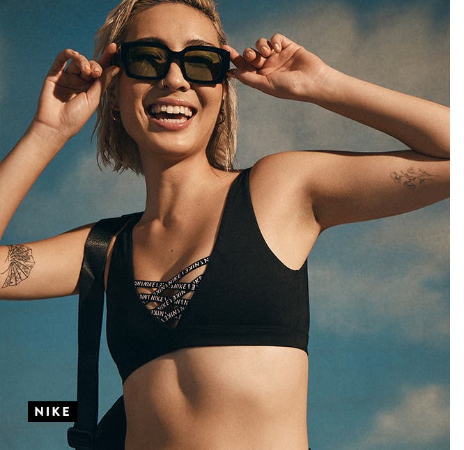 A woman wearing a black Nike swim top.
